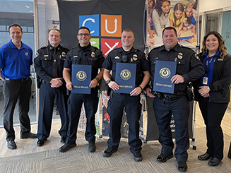 Police officers and Credit Union of Texas employees posing for a picture